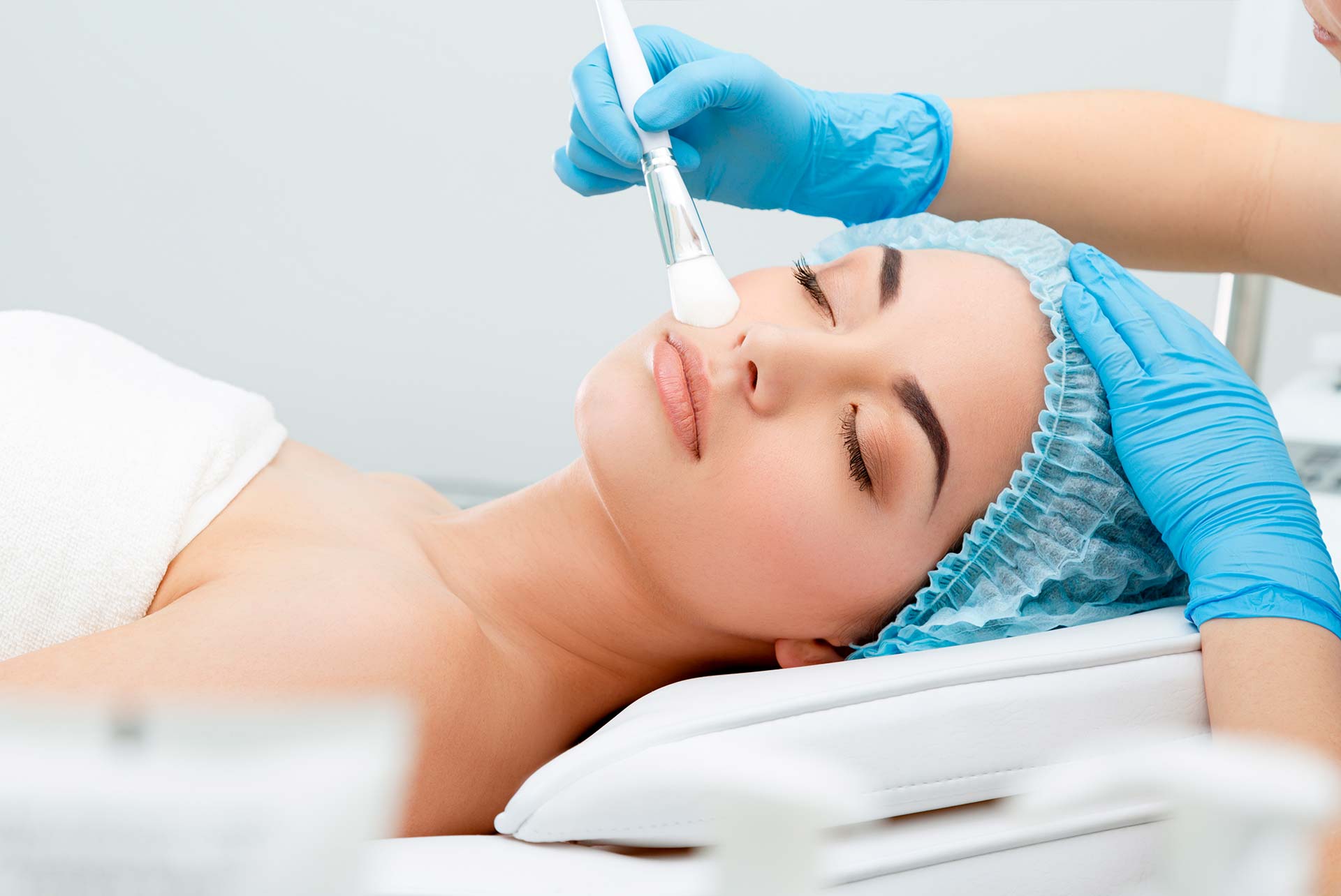 Woman lying down relaxing at spa getting a gentle Chemical Peel Facial - Skinworks Wellness & Aesthetics