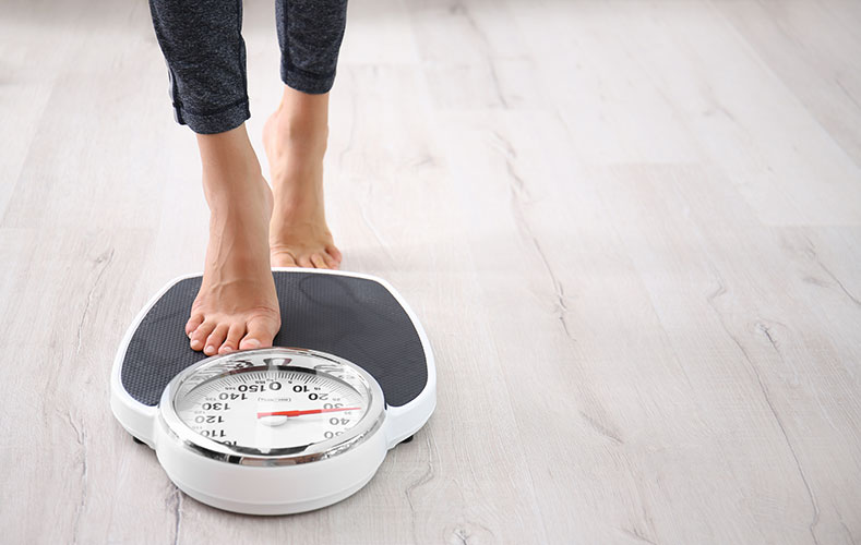 Woman standing on a weighscale - Semaglutide Injections for weight loss by Skinwork Wellness & Aesthetics - Medspa, Hendersonville, TN