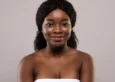 Young beautiful black woman with clean and smooth skin posing after bath