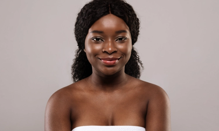 Young beautiful black woman with clean and smooth skin posing after bath