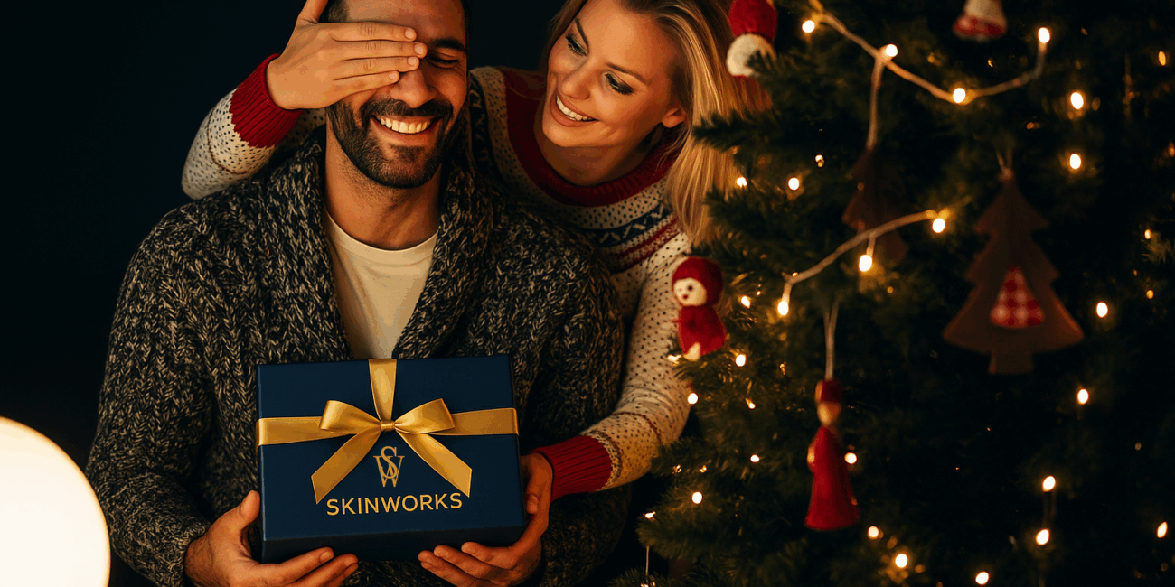 Brunette man and blonde woman exchanging Christmas Gifts - Skinworks Membership