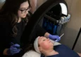 Esthetician performing a microneedling treatment on a client's face at Skinworks Wellness